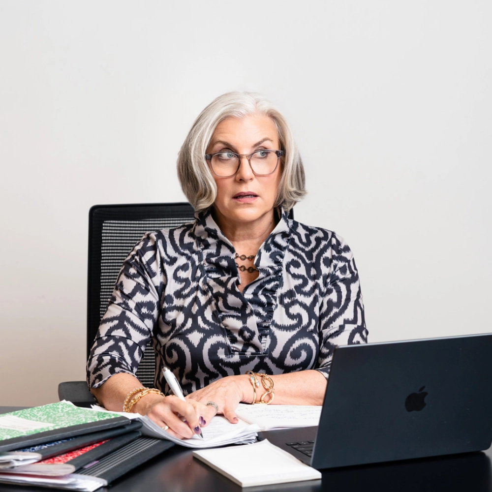 Cindi Sutera working at her desk