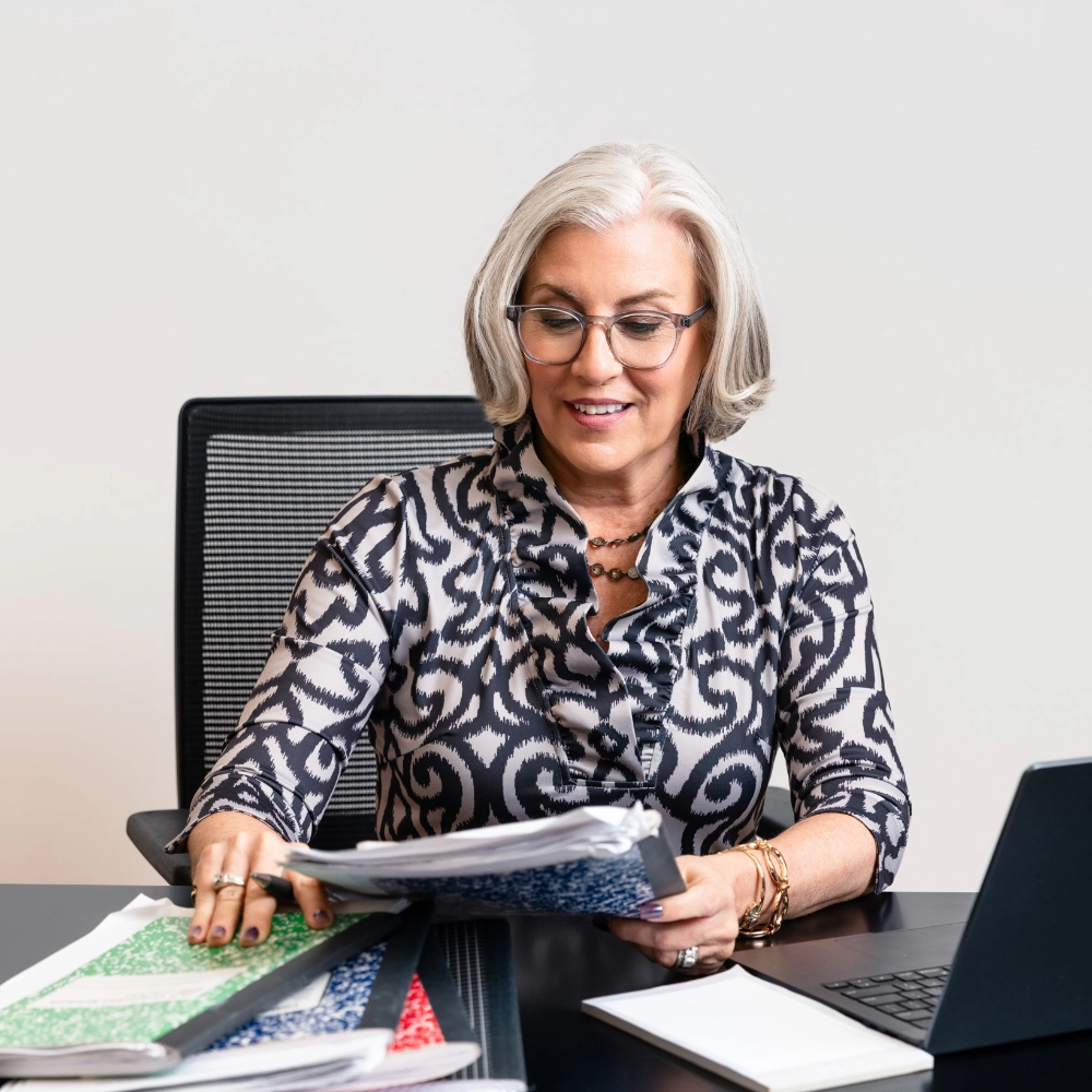 Cindi Sutera working at her desk